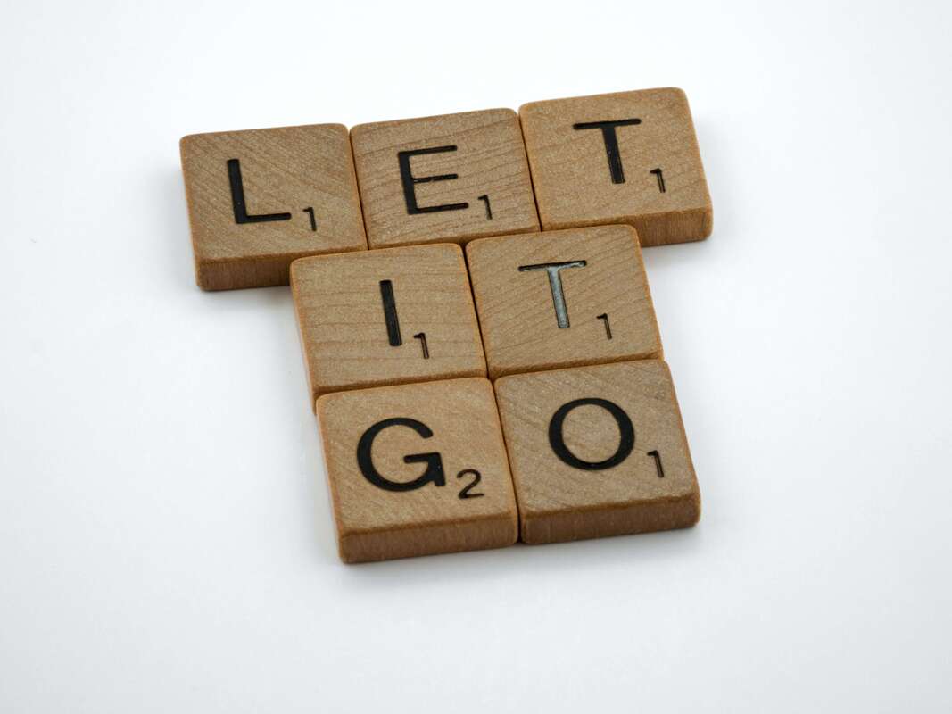 Scrabble pieces spelling out Let It Go.