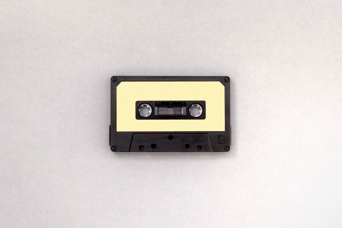 Black and ivory cassette tape.