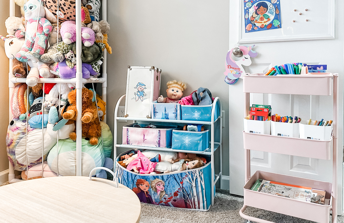 Playroom toy storage including stuffed animal cage, Frozen bins, and pink art cart.