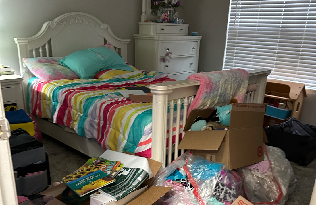 Girl bedroom with moving boxes and toys blocking floor