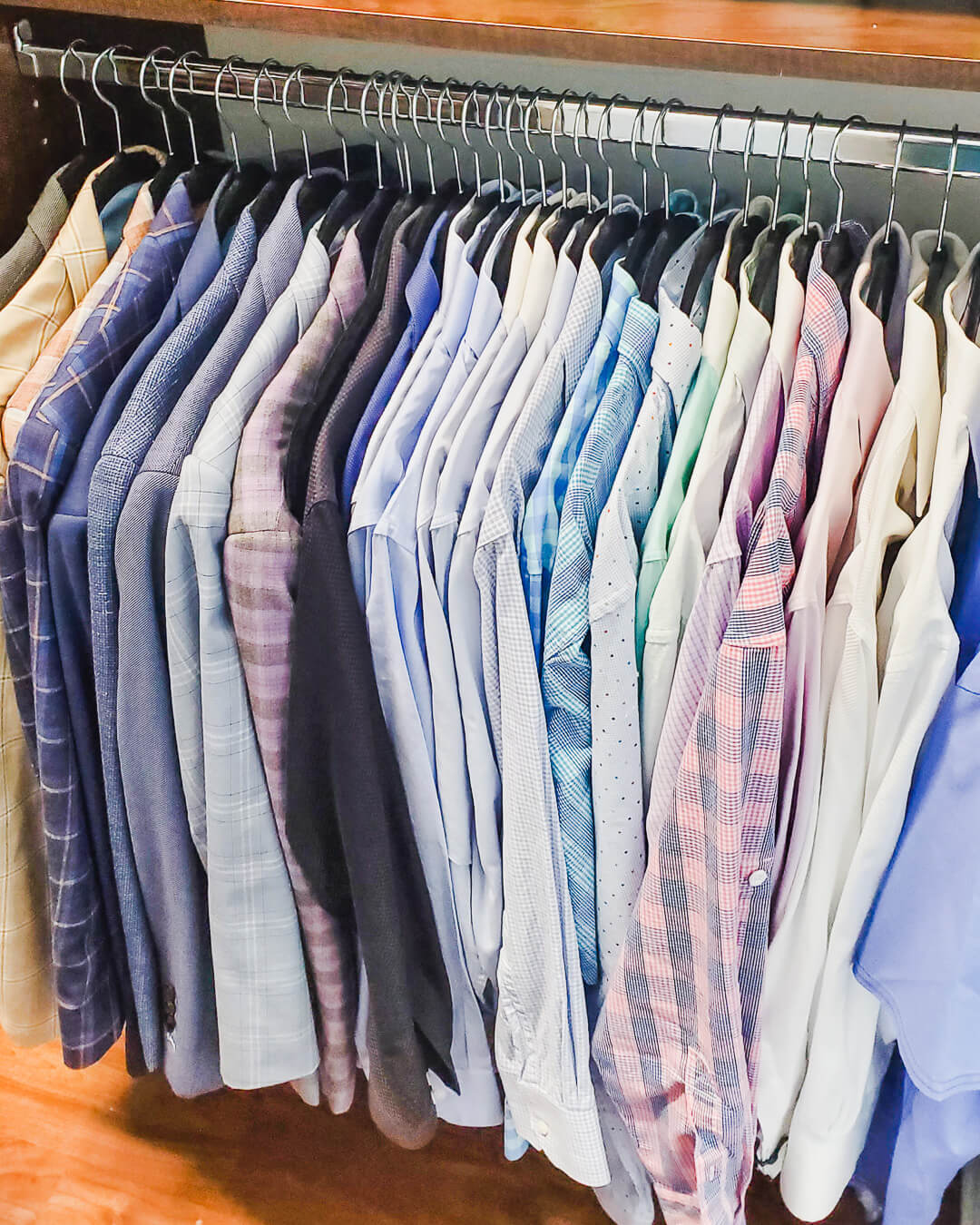 Men's dress shirts organized in color order