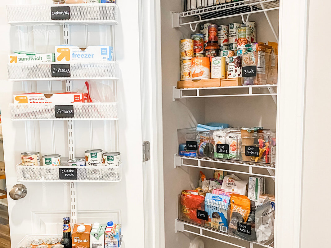 Small pantry closet organized with clear bins and chalkboard labels