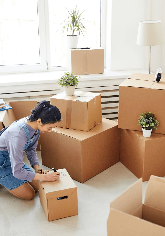Professional organizer labeling a moving box after packing the client's home
