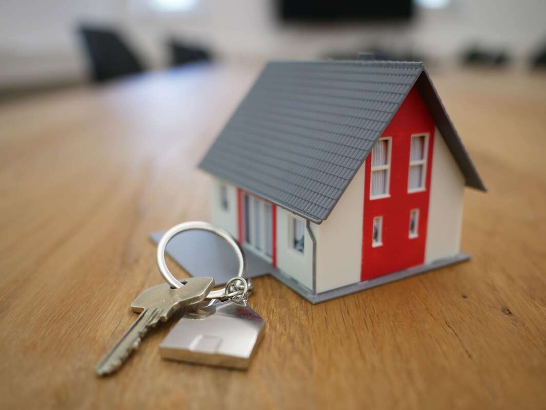 Little red house keychain with key.